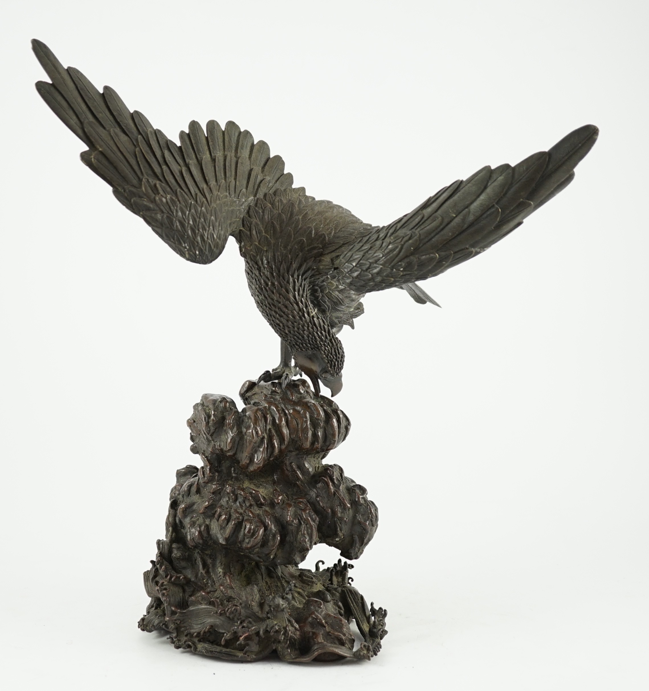 A Japanese bronze model an eagle standing on a rock, Meiji period, 44.5cm high